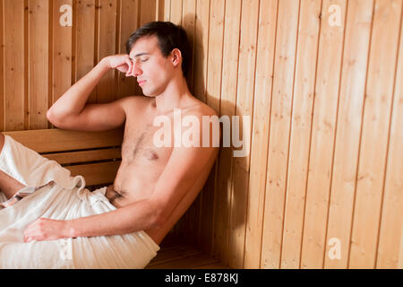 Young man relaxing in the sauna Stock Photo