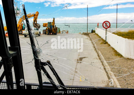 Broken front glass of  bus waiting on pier. Stock Photo