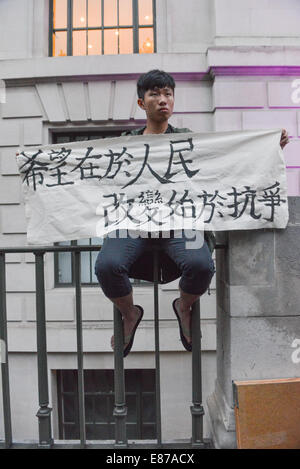 Portland Place, London, UK. 1st October 2014. Protesters hold banners and umbrellas opposite the Chinese Embassy in London, in support of the “umbrella revolution” that is taking place in Hong Kong. Credit:  Matthew Chattle/Alamy Live News Stock Photo