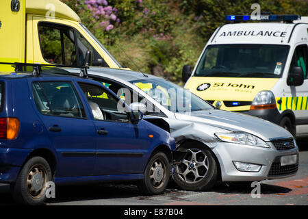 Two cars involved in a side impact road traffic accident collision, with ambulance in attendance UK Stock Photo