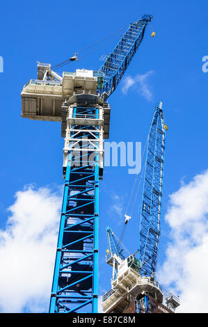 Two high cranes on construction site in London England United Kingdom UK Stock Photo