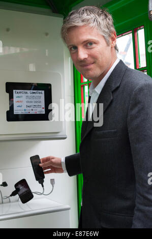 London, UK. 1st October, 2014.  The first traditional London telephone box to be transformed into a solar-powered mobile phone charger, for the general public to use free of charge, is unveiled on Tottenham Court Road by winners of the Mayor’s Low Carbon Entrepreneur 2014 competition. Pictured: Zac Goldsmith MP. Credit:  Lee Thomas/Alamy Live News Stock Photo