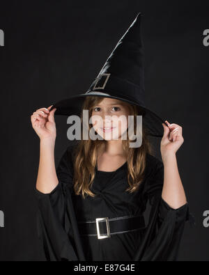 Young girl models in studio in various costumes and poses. Stock Photo