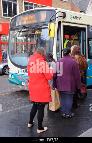 queue of people boarding Arriva single decker bus, Leicester, England, UK