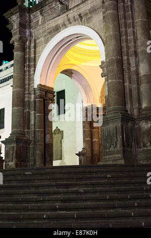 The Carondelet Arch of the Metropolitan Cathedral on Plaza Grande (main square) at night in the city center in Quito, Ecuador Stock Photo