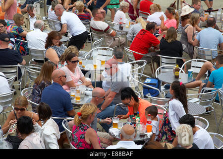 People sat enjoying food and drink outside at the Cardiff bay festival, Wales, UK. Stock Photo