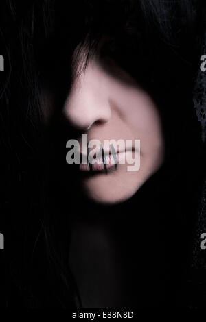 Dark female character with a black cape Stock Photo