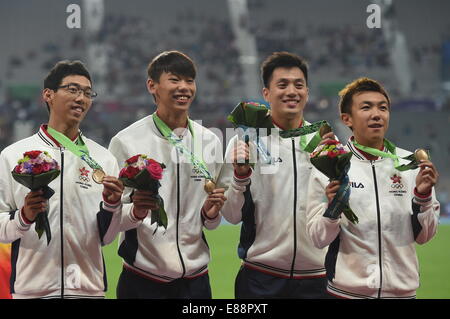 Incheon, South Korea. 2nd Oct, 2014. Bronze medalists athletes of China's Hong Kong pose on the podium during the awarding ceremony of the the men's 4X100 relay match of athletics at the 17th Asian Games in Incheon, South Korea, Oct. 2, 2014. © Gong Lei/Xinhua/Alamy Live News Stock Photo