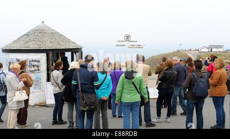 A group of tourists standing in front of the famous signpost Cornwall England uk Stock Photo