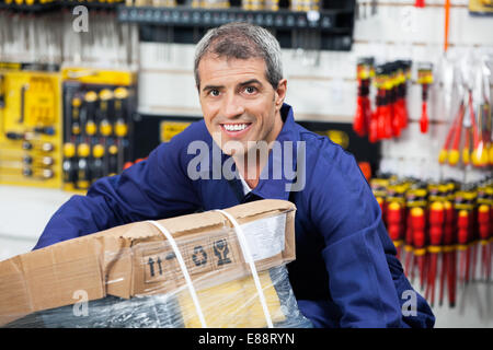Worker Lifting Tool Package In Hardware Shop Stock Photo