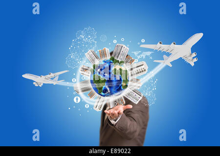 Businessman holding earth with buildings Stock Photo