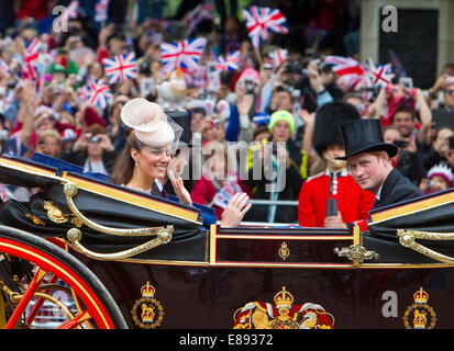 The Duchess of Cambridge,Catherine Middleton,her husband,William and Prince Harry ride down the Mall Stock Photo