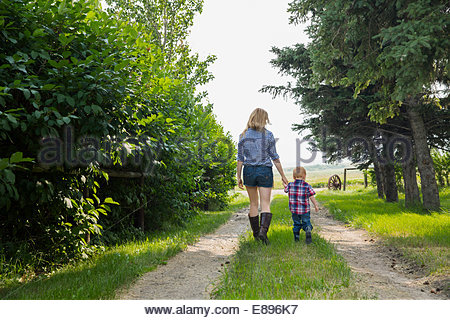 Mother and son walking on rural road