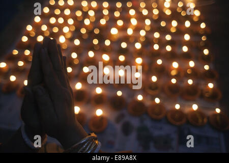 Dhaka, Bangladesh. 2nd Oct, 2014. Lamps burn as a tribute to the goddess Durga in worship at Shakharibaza temple in Dhaka, Bangladesh.Thousands of Bangladeshi devotees celebrate the traditional festival Durga Puja, the worshipping of the Hindu goddess Durga. Common customs include the application of Sindoor powder on married women, the sacrifice of animals and the worship of deities Credit:  Zakir Hossain Chowdhury/ZUMA Wire/Alamy Live News Stock Photo