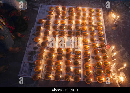 Dhaka, Bangladesh. 2nd Oct, 2014. Lamps burn as a tribute to the goddess Durga in worship at Shakharibaza temple in Dhaka, Bangladesh.Thousands of Bangladeshi devotees celebrate the traditional festival Durga Puja, the worshipping of the Hindu goddess Durga. Common customs include the application of Sindoor powder on married women, the sacrifice of animals and the worship of deities Credit:  Zakir Hossain Chowdhury/ZUMA Wire/Alamy Live News Stock Photo