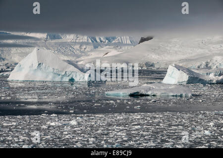 A view across the frozen landscape and icebergs of Charlotte Bay in Antarctica Stock Photo