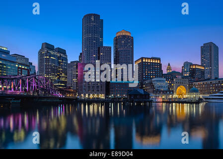 Boston Harbor skyline. The Old Northern Bridge can be seen on the left, the Custom House Clock Tower as well as Rowes Wharf, along with other high rises along the waterfront. Also available as a black and white print. Stock Photo