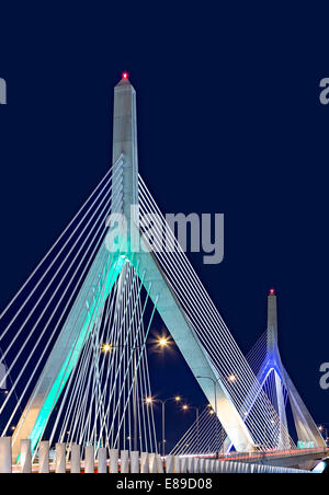 A view to the Leonard P. Zakim Bunker Hill Memorial Bridge at twilight.  The Zakim bridge, was  part of The Big Dig Project in Boston. It is one of the widest cable-stayed bridges in the world. The Bridge serves as the northern entrance to and exit from Boston. The Bridge is named after civil rights activist Lenny Zakim and the American colonists who fought the British in the Battle of Bunker Hill.  Also available as a color version photograph. Stock Photo