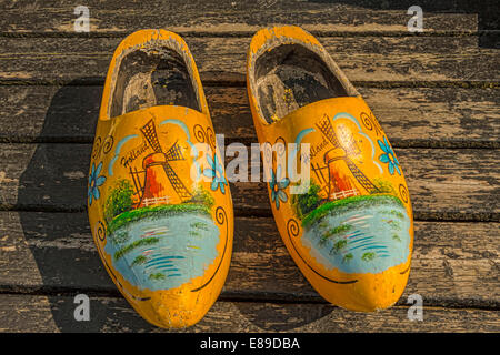 Dutch clogs or wooden shoes, decorated with a windmill and flowery design, Marken, Waterland, North Holland, The Netherlands. Stock Photo