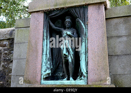 A bronze in the Dean Cemetery, Edinburgh depicting an angel pulling aside a curtain. Stock Photo