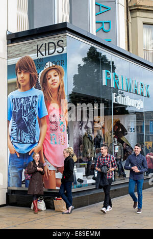 Young shoppers waiting and strolling by the Primark store on Princes Street, Edinburgh, Scotland, UK Stock Photo