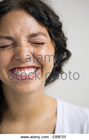 Close up of enthusiastic woman with eyes closed