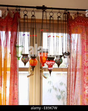 Close Of Red Moroccan Glass Lantern On Ceiling Of Neutral