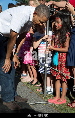 President Barack Obama, with First Lady Michelle Obama, greets military personnel and their families during the Fourth of July celebration on the South Lawn of the White House, July 4, 2014. Stock Photo