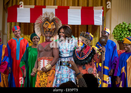 First Lady Michelle Obama joins the cast of Disney's 'The Lion King' onstage after their performance at the Kids' State Dinner in the East Room of the White House, July 18, 2014. Stock Photo