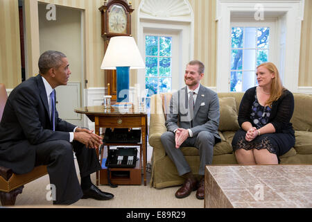 President Barack Obama meets with Dr. Kent Brantly and his wife, Amber, during an Oval Office drop by, Sept. 16, 2014. Dr. Brantly had contracted the Ebola virus while doing missionary aid work in Liberia. Stock Photo