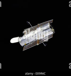 Orbiter Discovery performs a flyaround of the Hubble Space Telescope (HST) after redeployment on the second servicing mission de Stock Photo