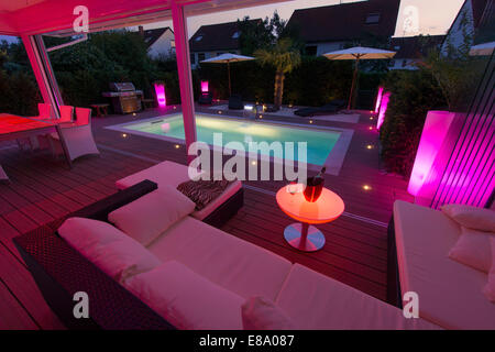 Private house at night with display lighting, a conservatory, a lounge, a pool and a terrace, Germany Stock Photo