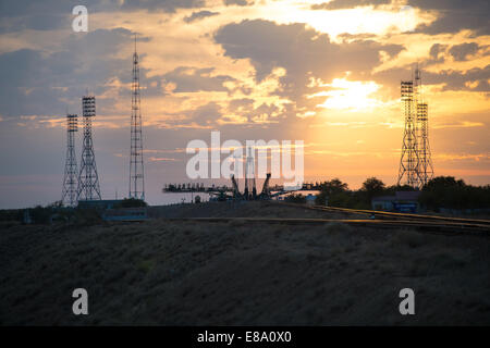 The sun rises behind the Soyuz launch pad as the Soyuz TMA-14M spacecraft is rolled out by train to the launch pad at the Baikonur Cosmodrome, Kazakhstan, Sept. 23, 2014. Launch of the Soyuz rocket is scheduled for Sept. 26 and will carry Expedition 41 So Stock Photo