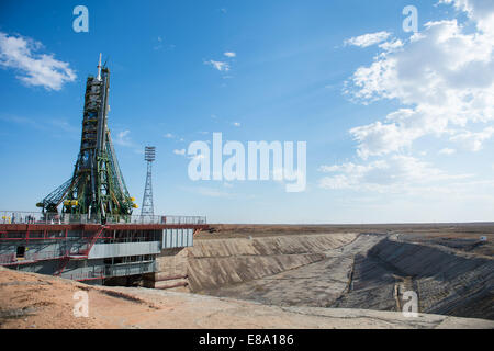 The Soyuz TMA-14M spacecraft is seen after the gantry arms closed securing the rocket in the veritcal position at the launch pad on Tuesday, Sept. 23, 2014 at the Baikonur Cosmodrome in Kazakhstan. Launch of the Soyuz rocket is scheduled for Sept. 26 and Stock Photo