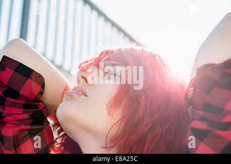 Teenage girl portrait day-dreaming red dyed hair Stock Photo