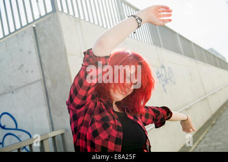 Young teenage girl dancing red dyed hair Stock Photo