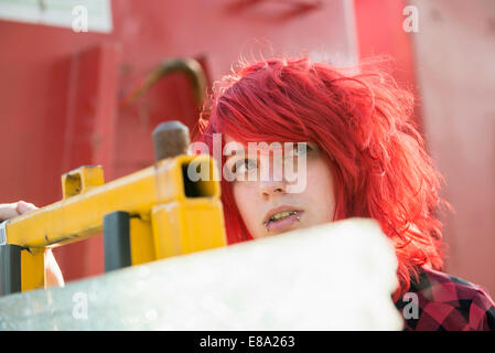 Young teenage girl dyed red hair piercings Stock Photo