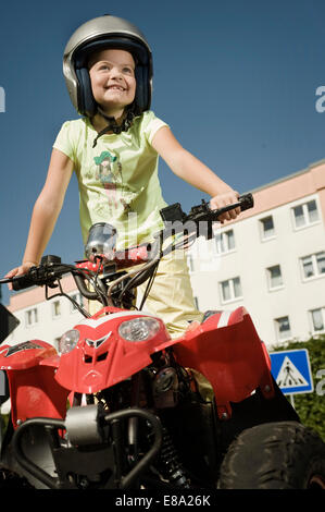 Smiling girl with quadbike on driver training area Stock Photo