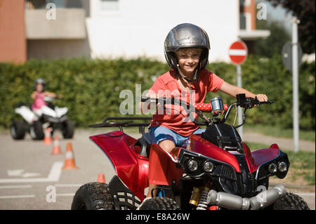 Smiling boy with quadbike on driver training area Stock Photo