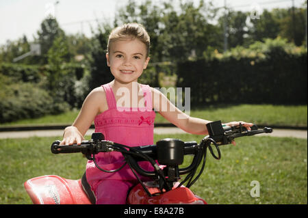 Smiling girl with quadbike on driver training area Stock Photo
