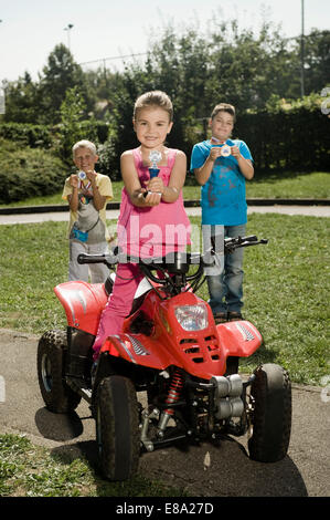 Three happy children with trophies at driver training area Stock Photo