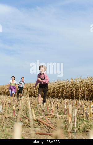 Family running in cornfield, Bavaria, Germany Stock Photo