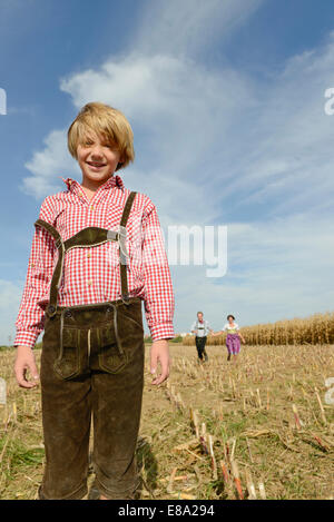 Family running in cornfield, Bavaria, Germany Stock Photo