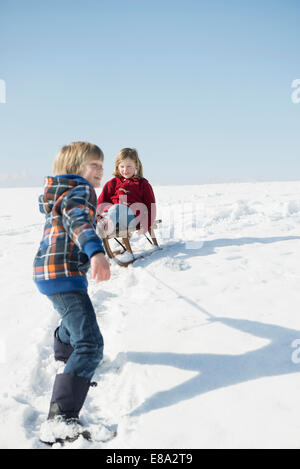 little-girl-pulls-boy-on-600w-