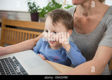Mother and son using laptop, close up Stock Photo
