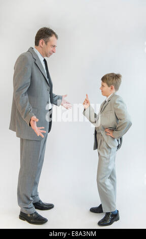Son blusters his father against white background Stock Photo
