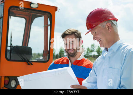Building owner and construction worker discussing  construction plan Stock Photo