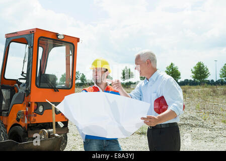 Building owner and construction worker discussing  construction plan Stock Photo