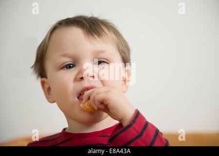 Boy eating mandarin Stock Photo