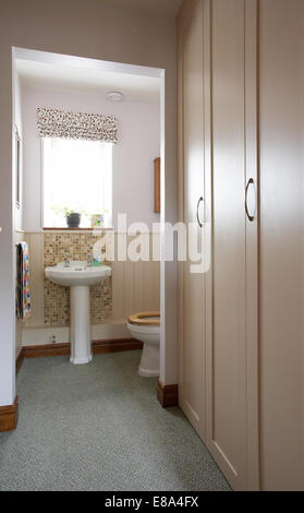 A downstairs cloakroom toilet and handbasin in a home in the UK. Stock Photo